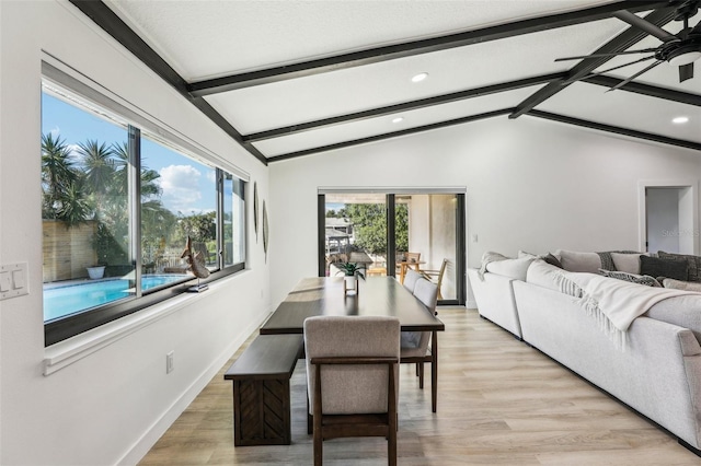 dining area with vaulted ceiling with beams, ceiling fan, and light hardwood / wood-style flooring