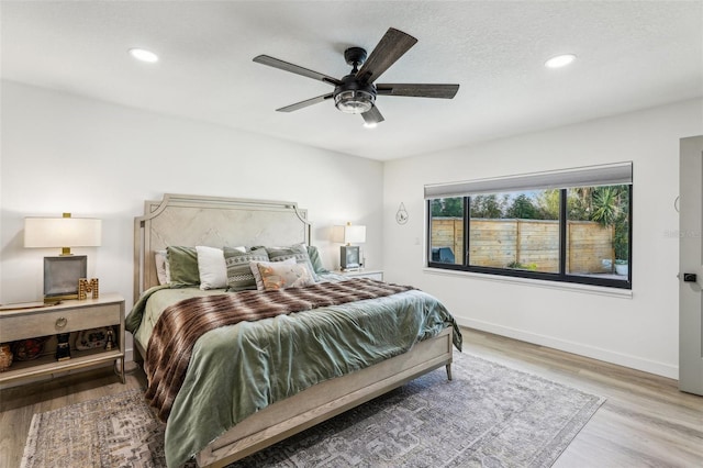 bedroom with ceiling fan and light wood-type flooring