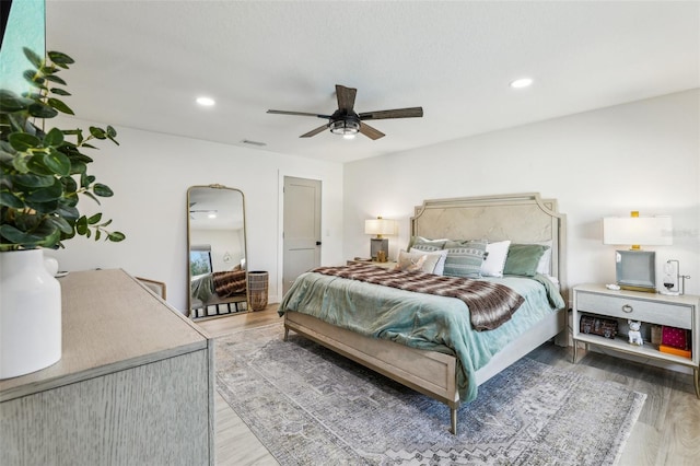 bedroom with hardwood / wood-style flooring and ceiling fan