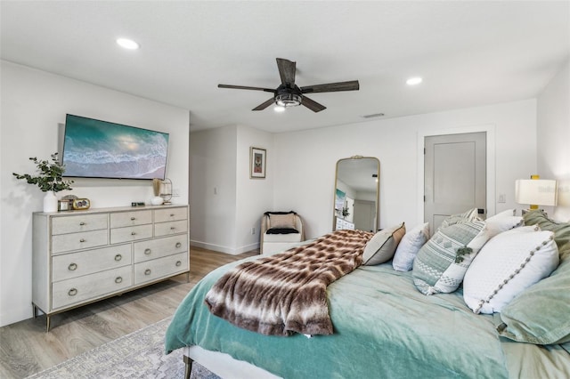 bedroom with ceiling fan and light hardwood / wood-style flooring