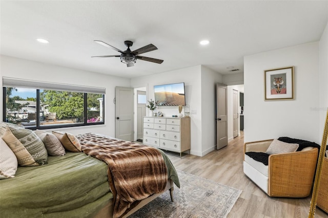 bedroom with ceiling fan and light hardwood / wood-style floors