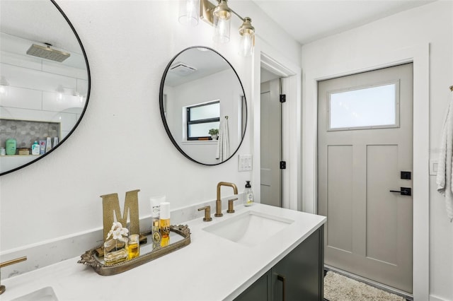 bathroom with a shower and vanity