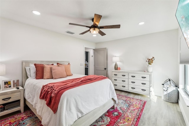 bedroom with ceiling fan and light hardwood / wood-style flooring