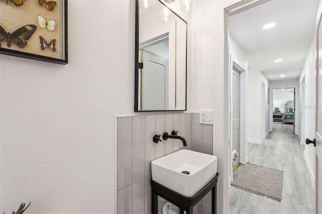 bathroom with wood-type flooring and sink