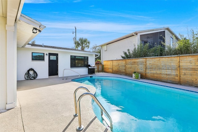 view of swimming pool with area for grilling and a patio area