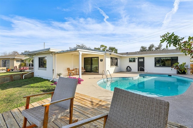 view of swimming pool featuring a yard and a wooden deck