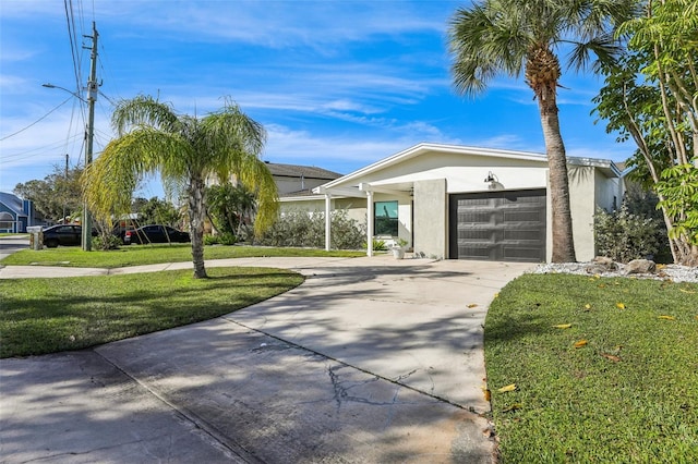 view of front of home featuring a front lawn and a garage