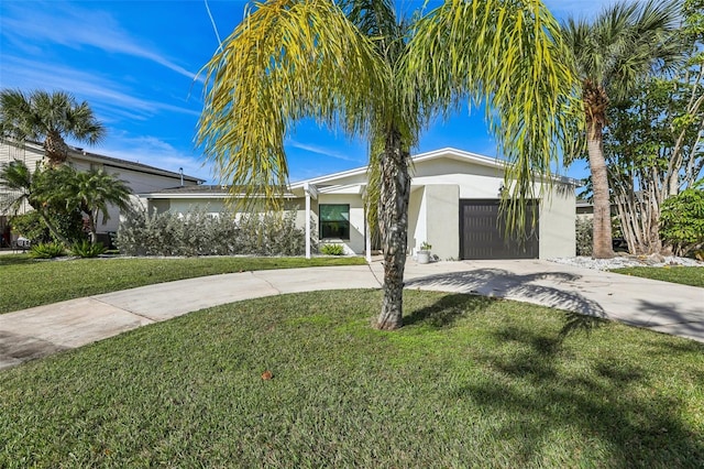 view of front of property featuring a front yard and a garage