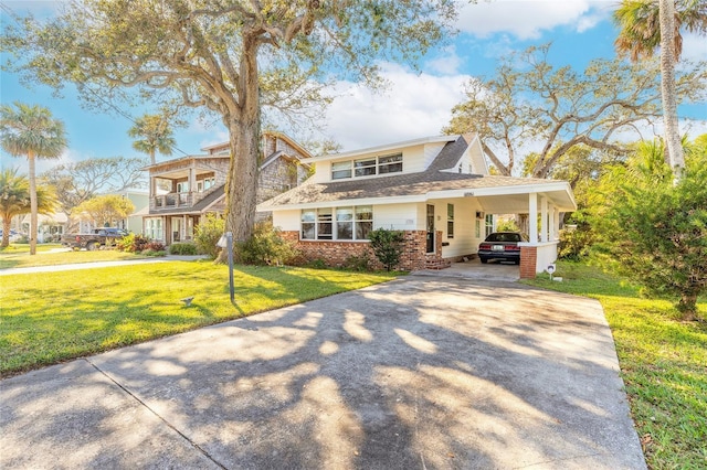 view of front of home with a front lawn and a carport