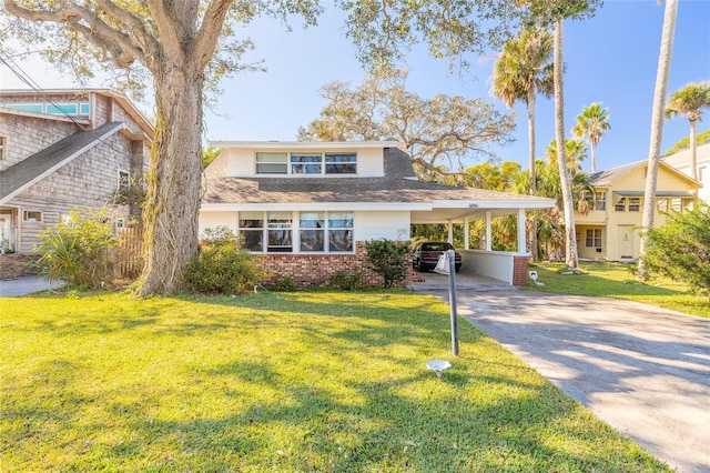 view of front of home with a front lawn and a carport