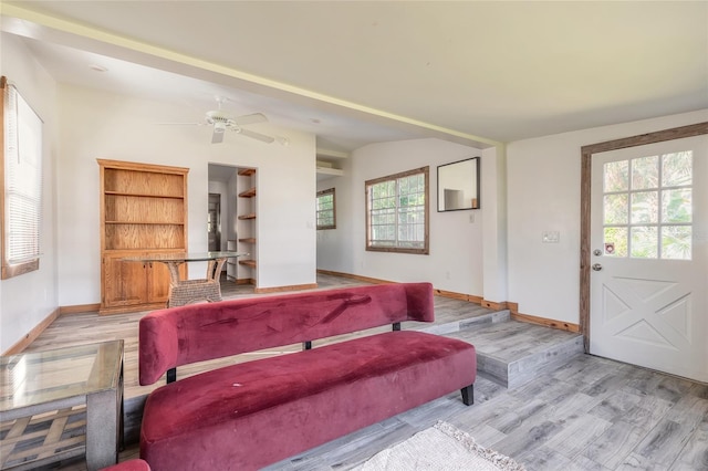 living room featuring light hardwood / wood-style floors and ceiling fan