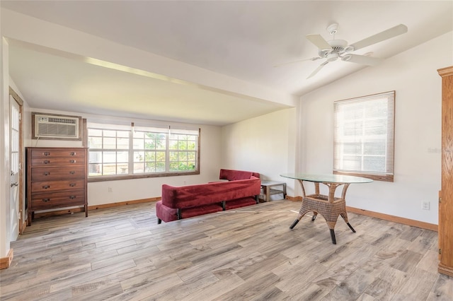 living area with a wall unit AC, ceiling fan, lofted ceiling, and light wood-type flooring