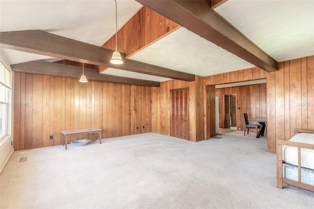 basement featuring light carpet and wooden walls