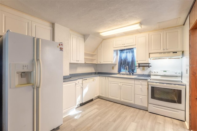 kitchen with sink, a textured ceiling, white appliances, white cabinets, and light wood-type flooring