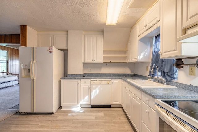 kitchen featuring white cabinets, a textured ceiling, white appliances, and sink