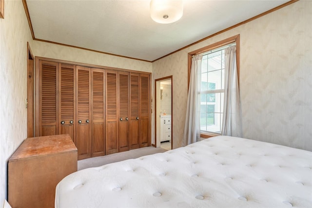 bedroom featuring multiple windows, crown molding, and a closet