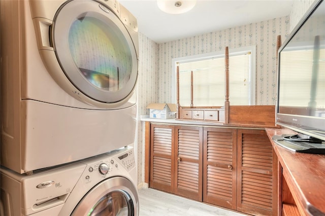 laundry room featuring stacked washer and clothes dryer