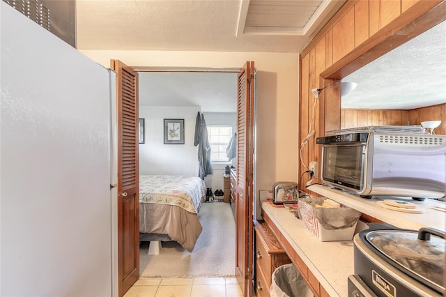 bedroom featuring wood walls and light carpet