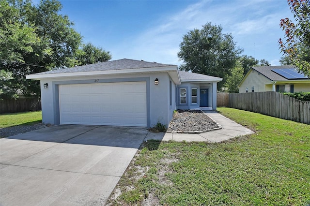 ranch-style home with a front lawn and a garage