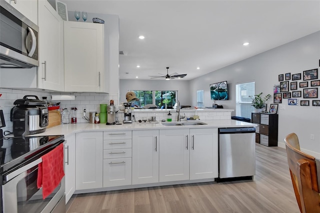 kitchen with ceiling fan, sink, white cabinets, and appliances with stainless steel finishes