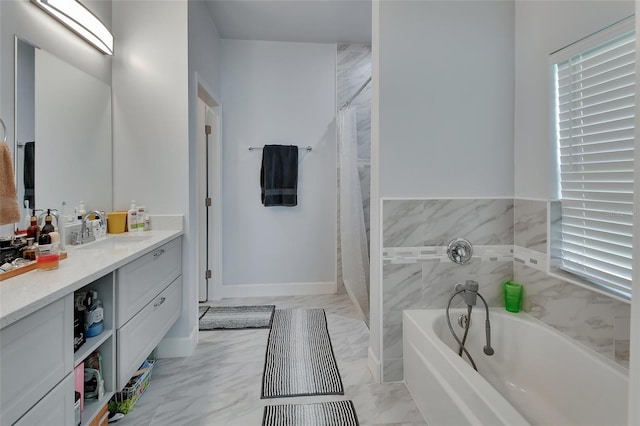 bathroom featuring a washtub and vanity