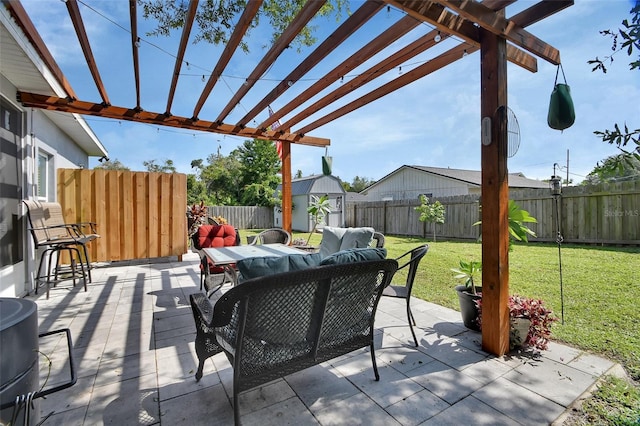 view of patio / terrace featuring a pergola, outdoor lounge area, and a storage unit