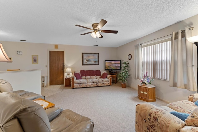 carpeted living room with ceiling fan and a textured ceiling