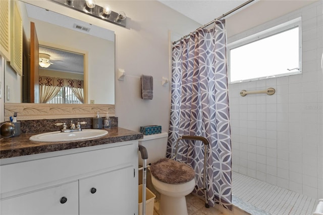 bathroom with vanity, curtained shower, a textured ceiling, and toilet