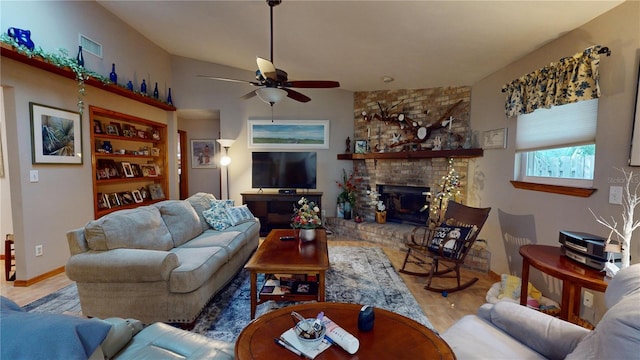 living room featuring ceiling fan, hardwood / wood-style floors, and a brick fireplace