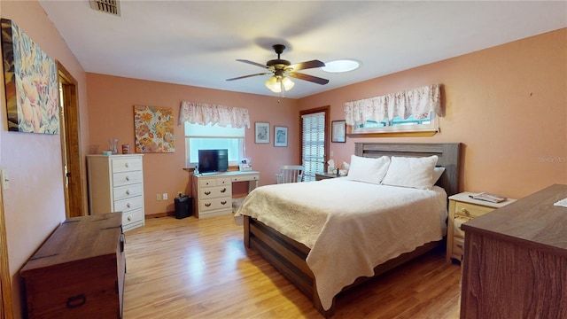 bedroom with ceiling fan and light wood-type flooring