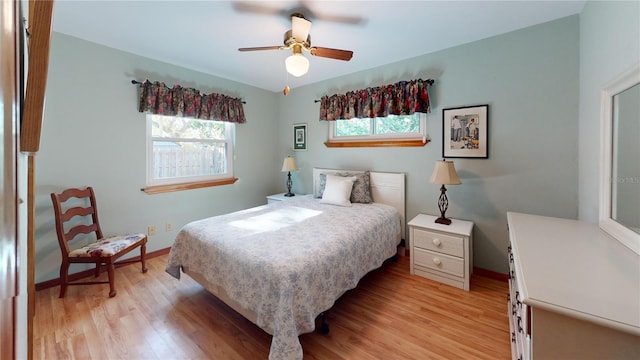 bedroom with light hardwood / wood-style floors and ceiling fan