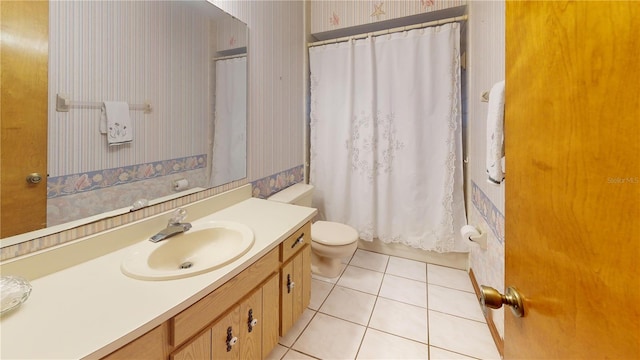 bathroom with tile patterned floors, vanity, and toilet