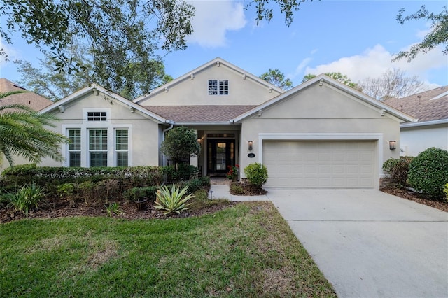 view of front of house with a garage and a front lawn