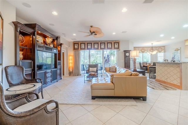 tiled living room featuring ceiling fan with notable chandelier