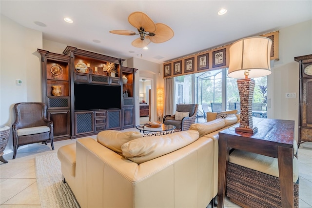 tiled living room featuring ceiling fan and a healthy amount of sunlight