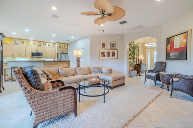 tiled living room featuring ceiling fan