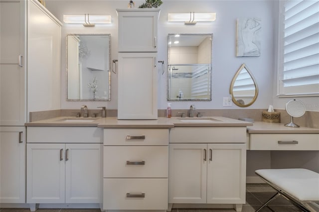 bathroom featuring a shower with shower door and vanity