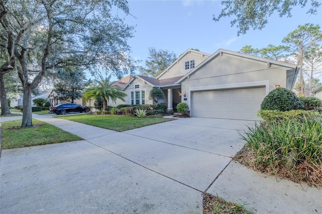 view of front of home with a garage and a front lawn