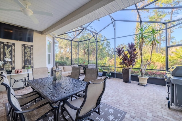 view of patio / terrace featuring glass enclosure, ceiling fan, and area for grilling