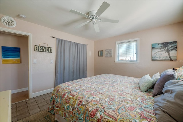 tiled bedroom featuring ceiling fan