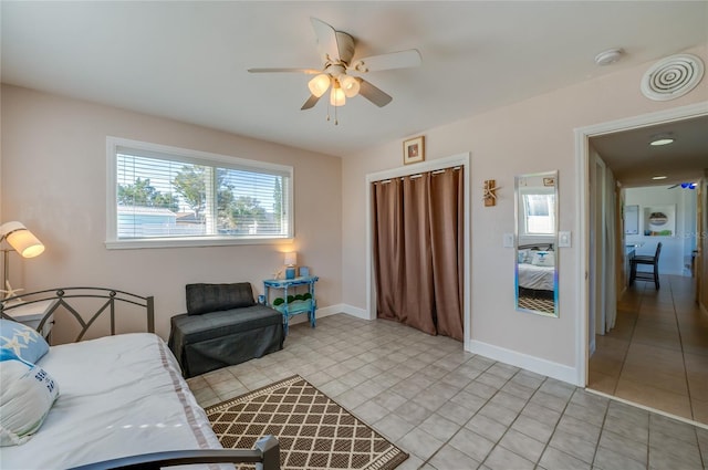 living room featuring light tile patterned floors and ceiling fan