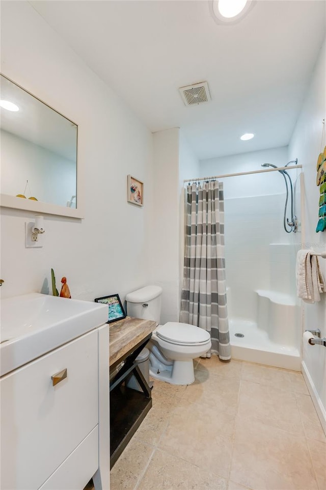 bathroom with vanity, toilet, and walk in shower