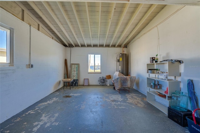 misc room with concrete flooring and vaulted ceiling