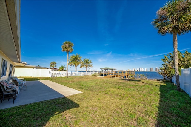 view of yard with a water view and a patio