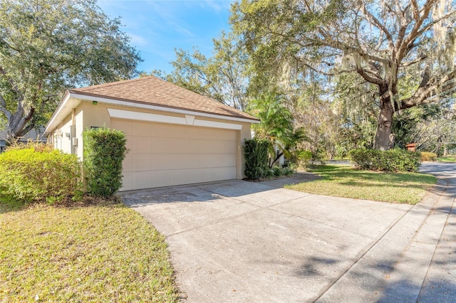 view of side of home featuring a lawn, an outbuilding, and a garage