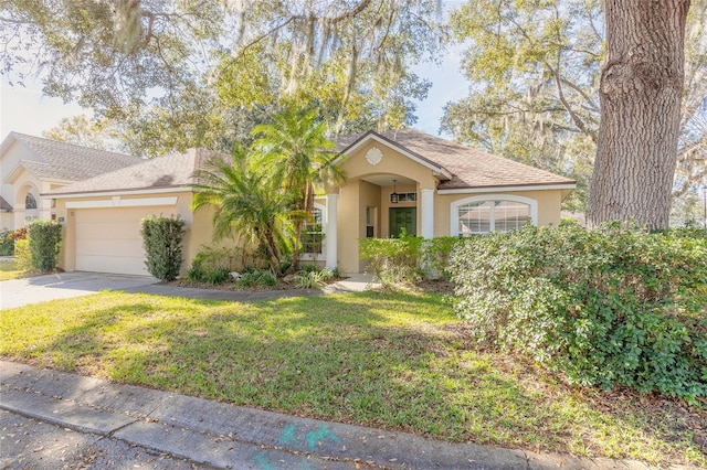 view of front of property with a front yard and a garage