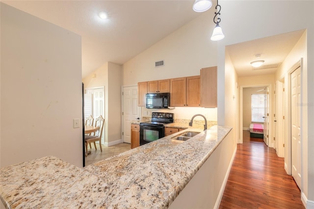 kitchen featuring kitchen peninsula, black appliances, and sink