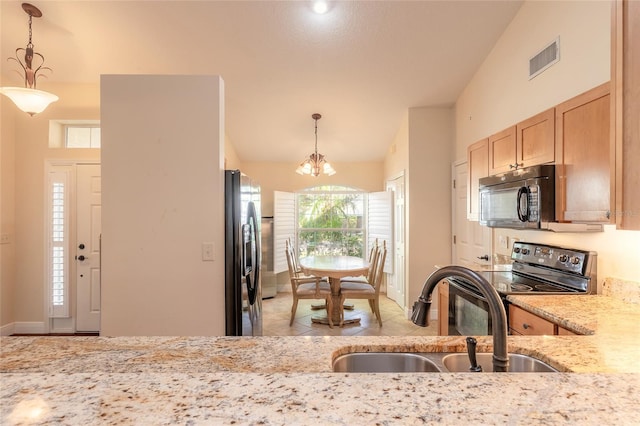 kitchen with sink, decorative light fixtures, light brown cabinetry, black appliances, and a notable chandelier