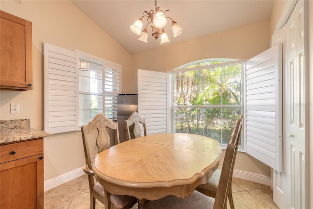 tiled dining area with an inviting chandelier, vaulted ceiling, and a wealth of natural light