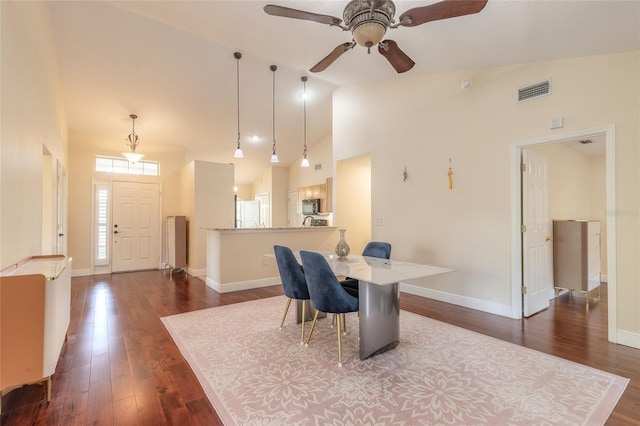 dining space with high vaulted ceiling, ceiling fan, and dark hardwood / wood-style floors